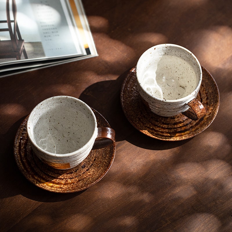 Japanese ceramic mug with gold foil accents on a wooden table.