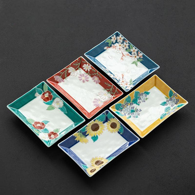 Collection of six Qingjiao kiln handmade plates with seasonal floral patterns.