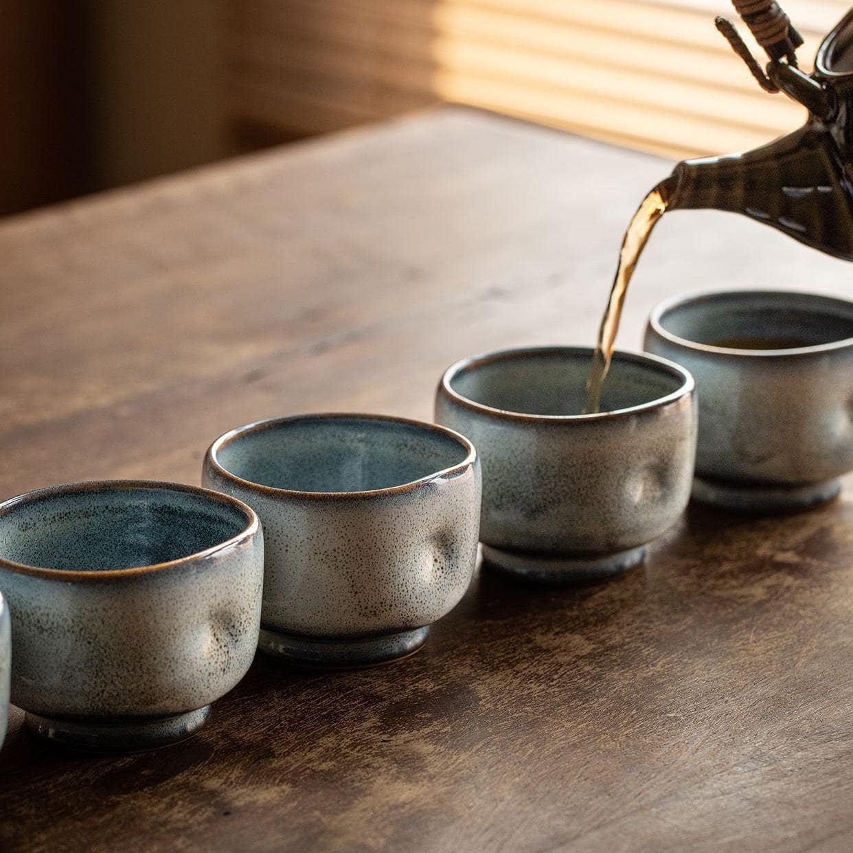 Vibrant blue Buhiki ware tea cups showcasing unique glazes