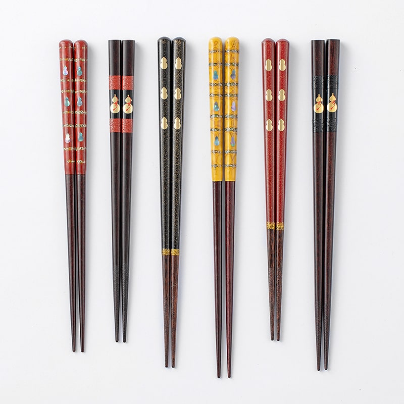 Premium wooden chopsticks featuring a vibrant red and black Fulu motif.