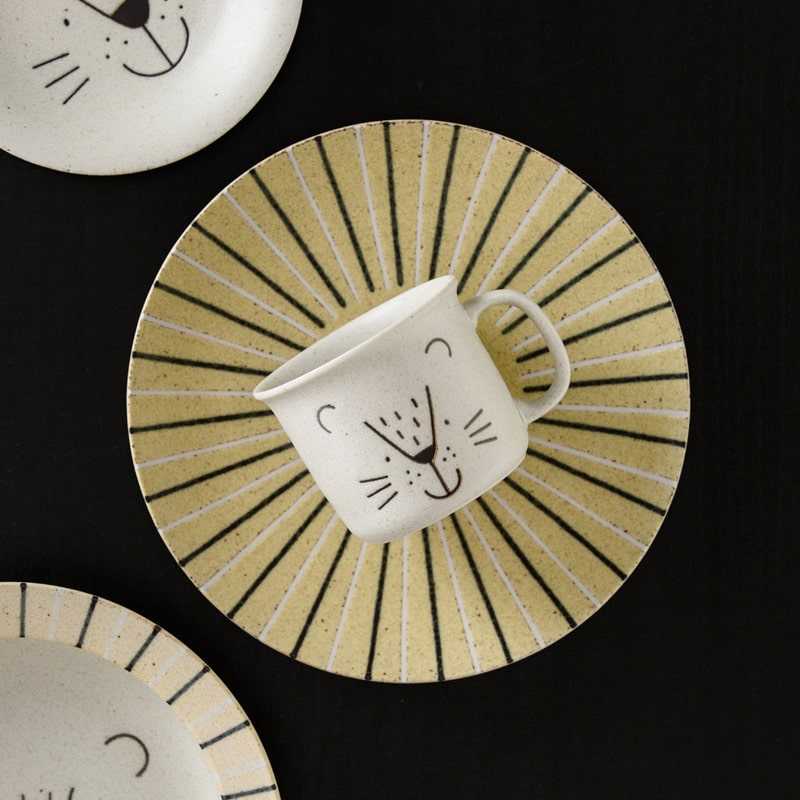 Close-up of ceramic plates featuring lion and seal designs.