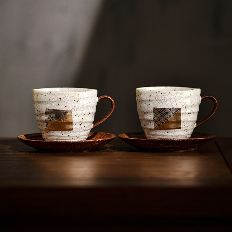 Couple ceramic mug set with foil details and matching saucers.