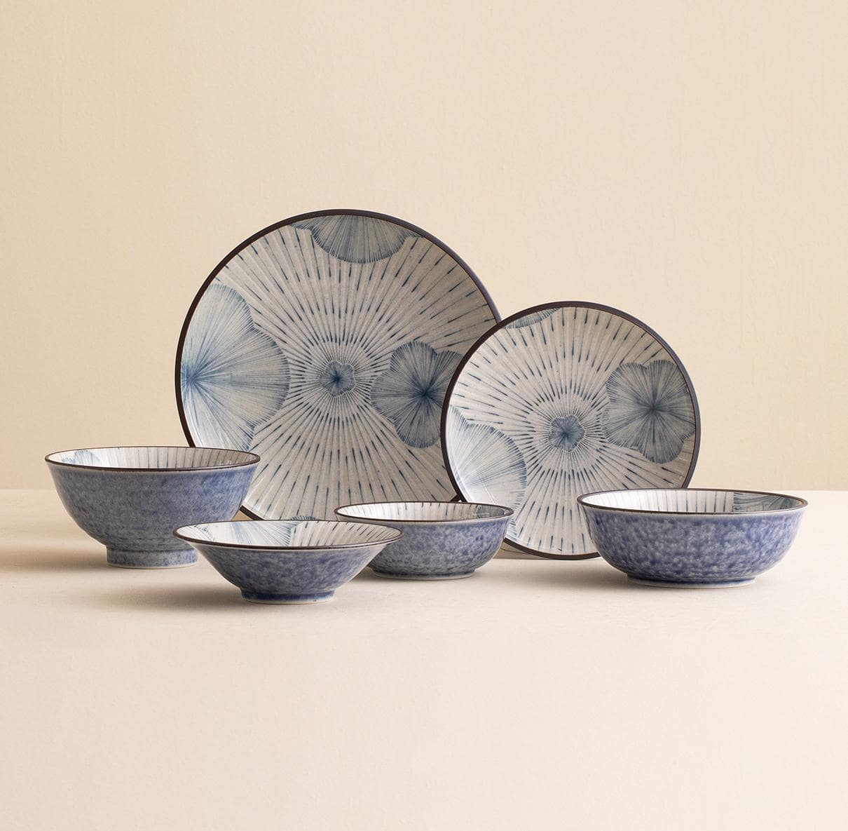 Elegant tableware set featuring plates and bowls with floral brush strokes