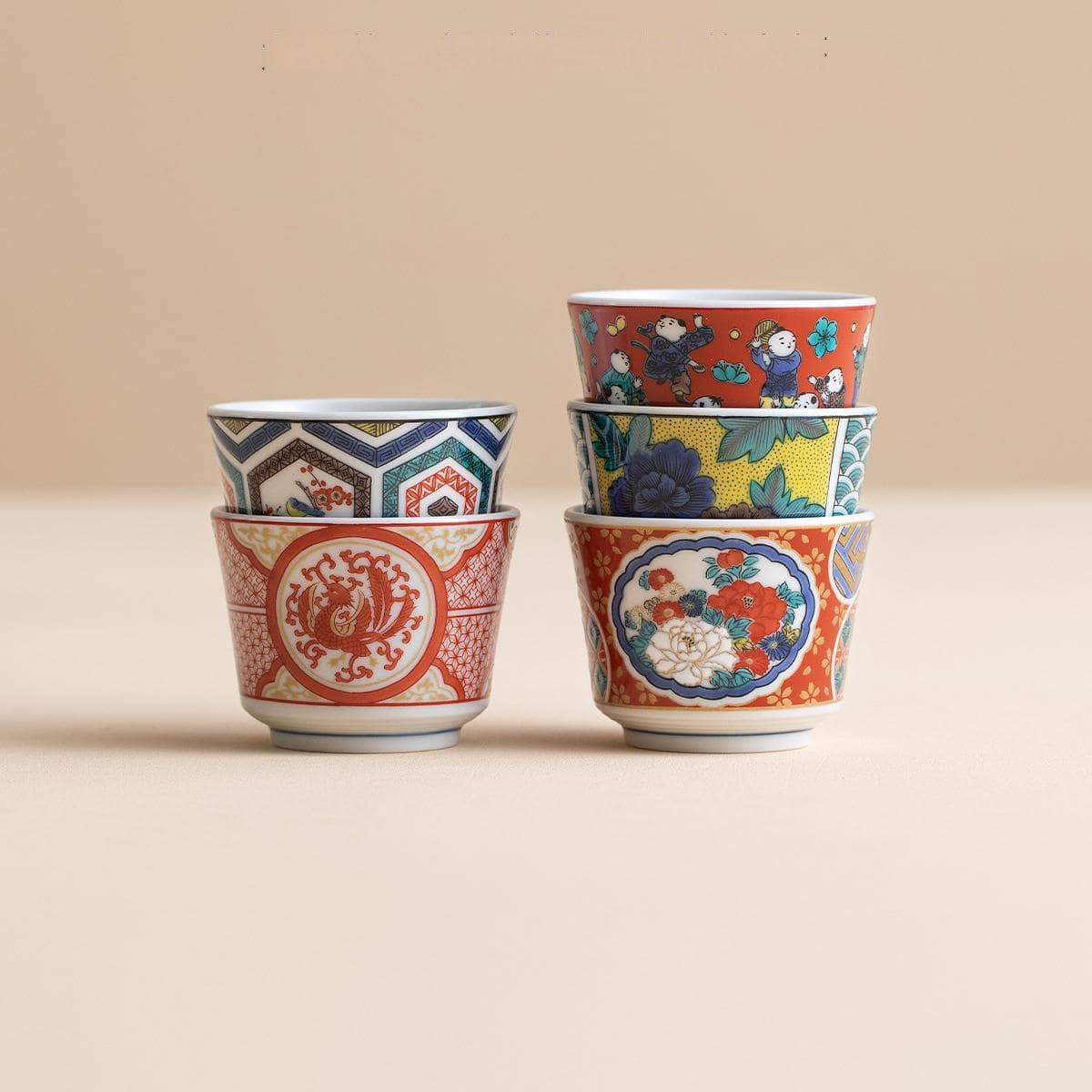 Hand-painted Japanese Kutani ware ceramic cup with floral design.