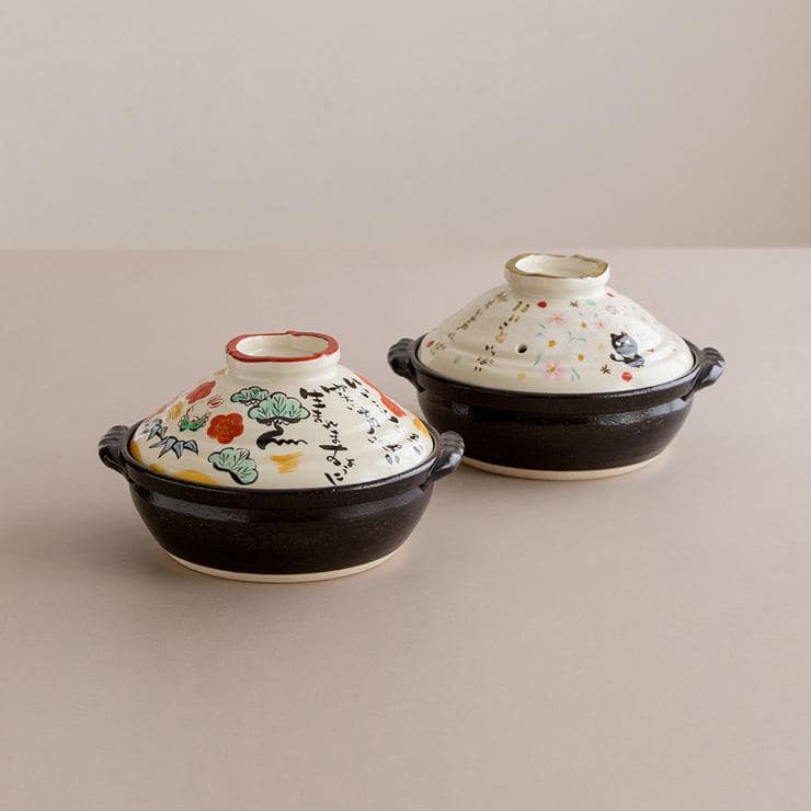 Two ceramic casserole pots showcasing unique Japanese artistry.