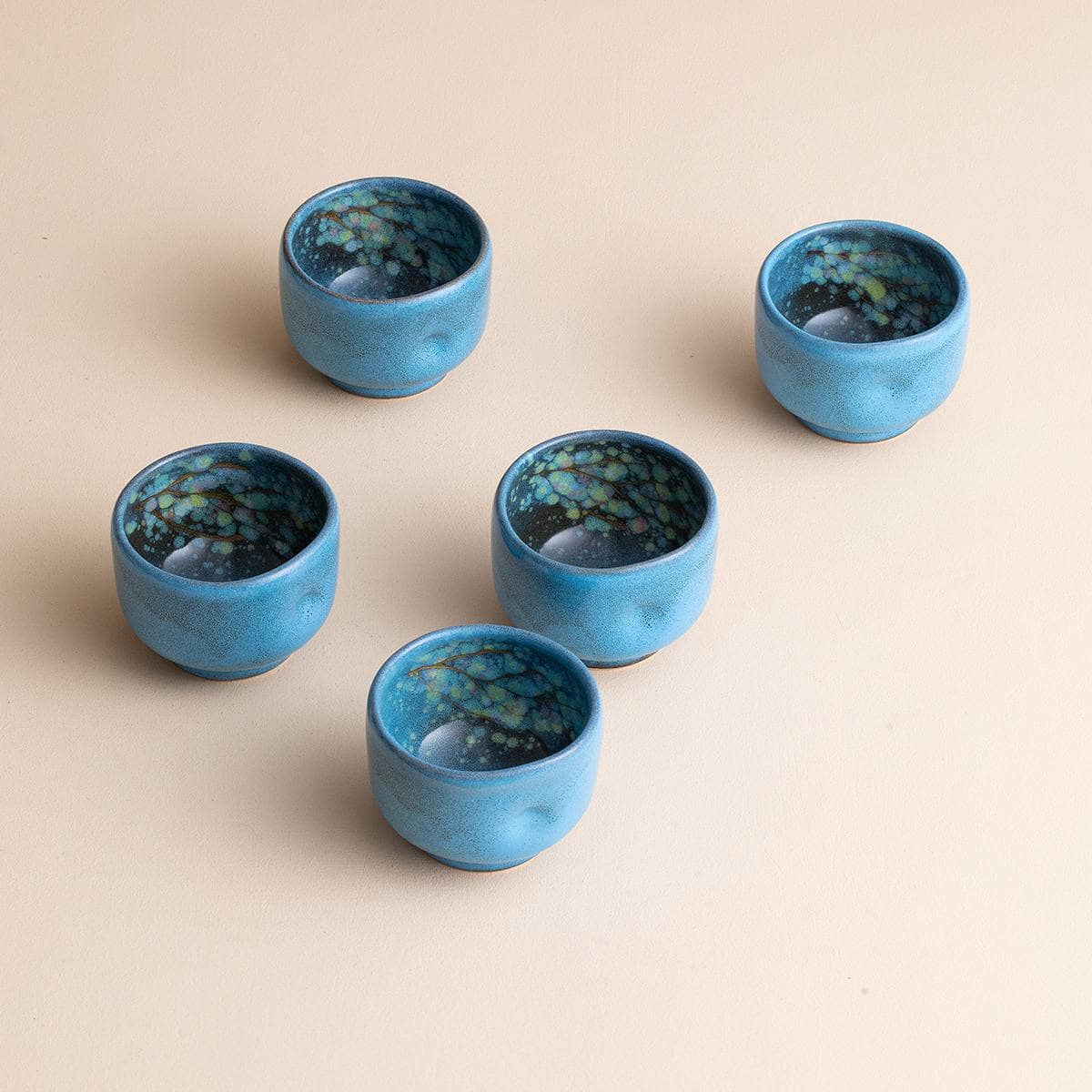 Japanese Buhiki tea cups with kiln-changed patterns on wooden table