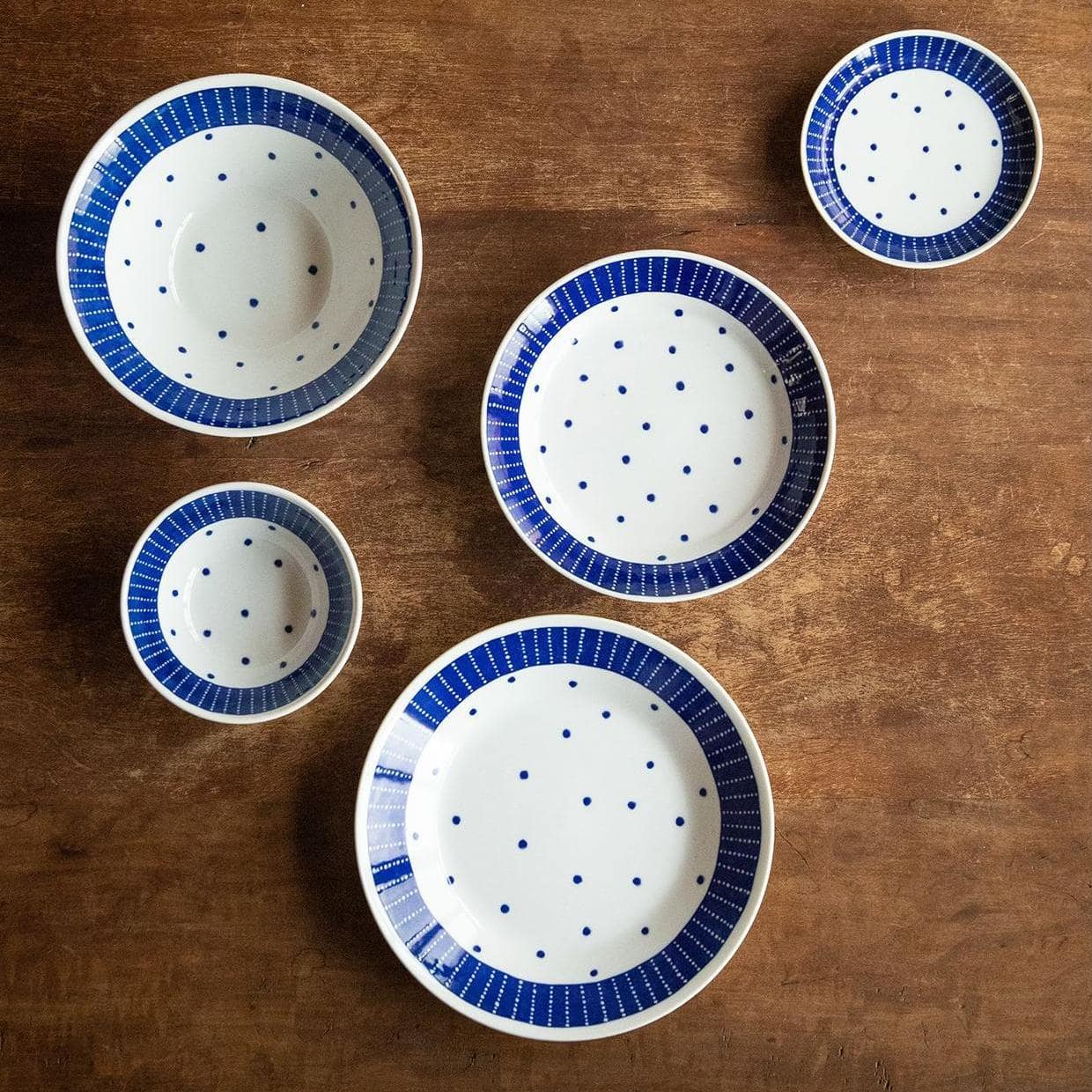 Deep ceramic plates and bowls for elegant dining.