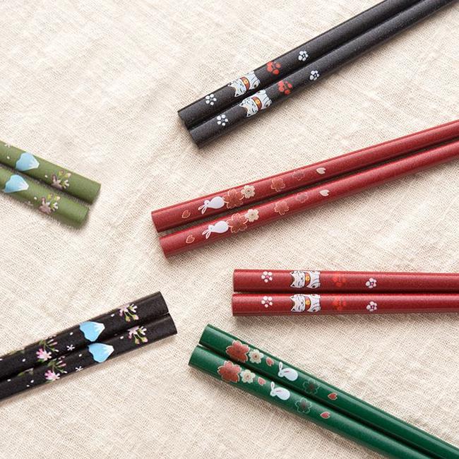 Assorted pointed wooden chopsticks with intricate designs