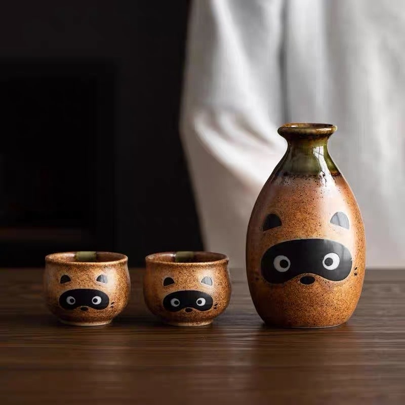 Raccoon-themed ceramic sake set with a rustic brown finish.