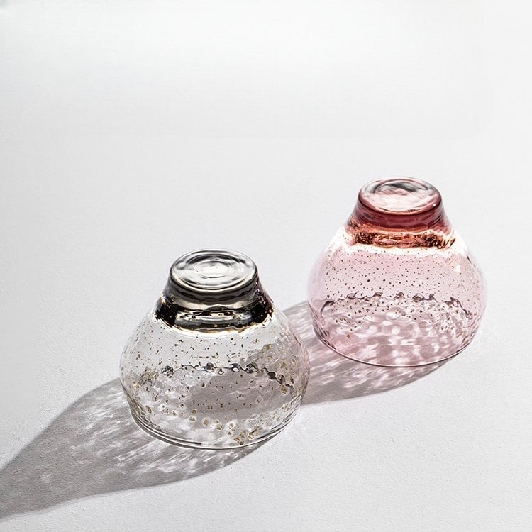 Transparent glass sake cup with embedded gold flecks.