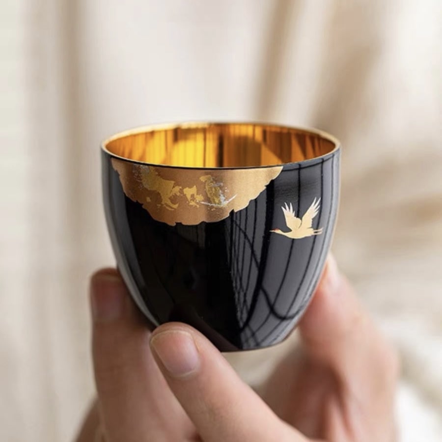 Luxury red and black tea cups with gold-leaf details for special occasions.