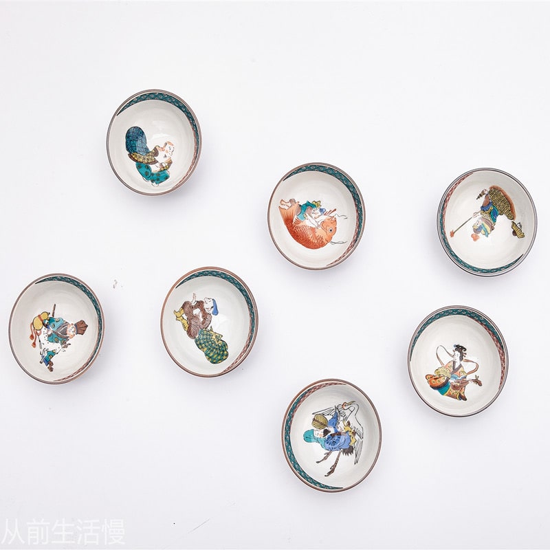 Detailed porcelain tea cups featuring colorful traditional artwork.