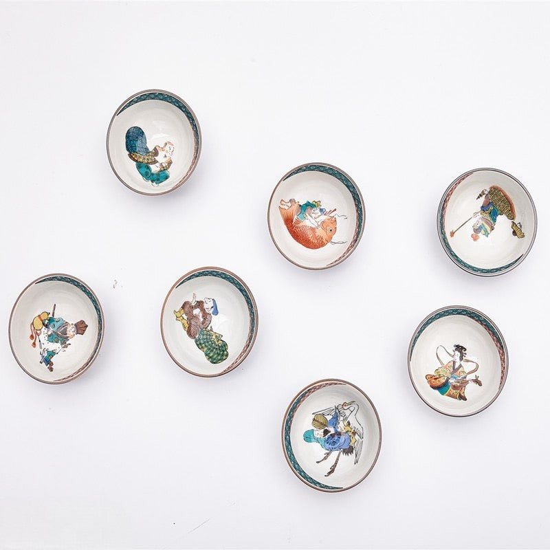 Hand-painted Japanese tea set with seven cups featuring traditional cultural motifs.