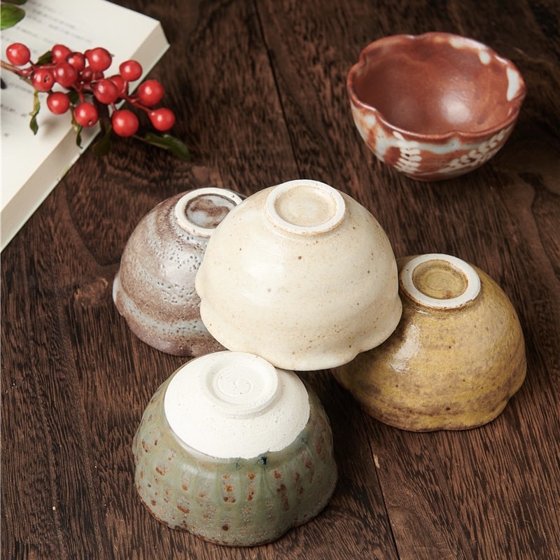 Close-up of delicate ceramic tea bowls with earthy tones and natural glazes.