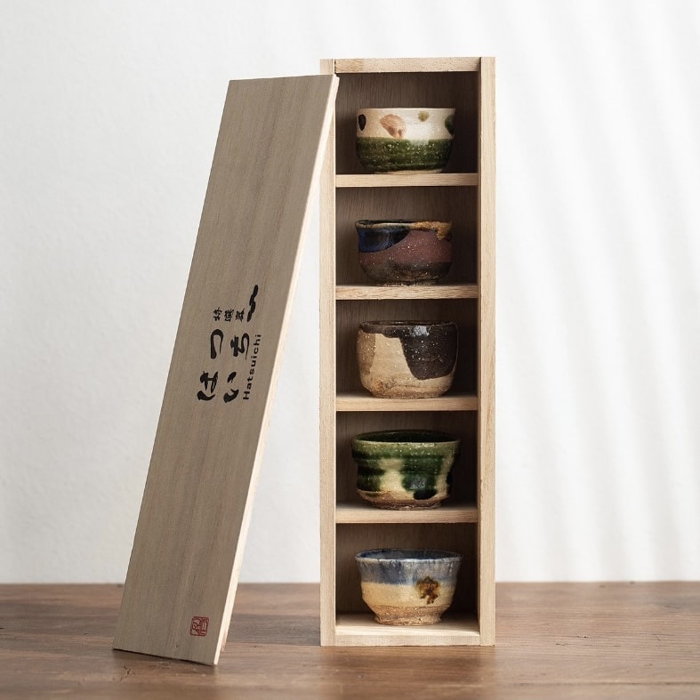 Rustic handcrafted ceramic tea cups in earthy tones.