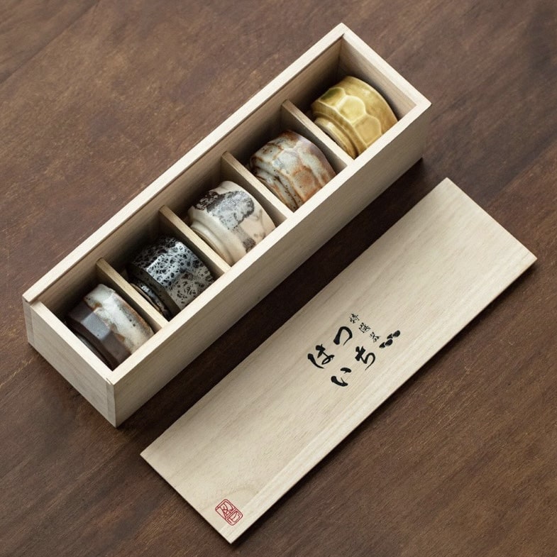 Handcrafted ceramic tea set with speckled and earthy finishes.