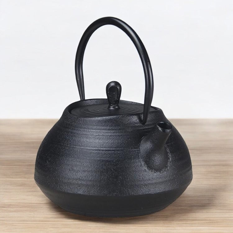 Sleek and durable cast iron teapot on a wooden surface