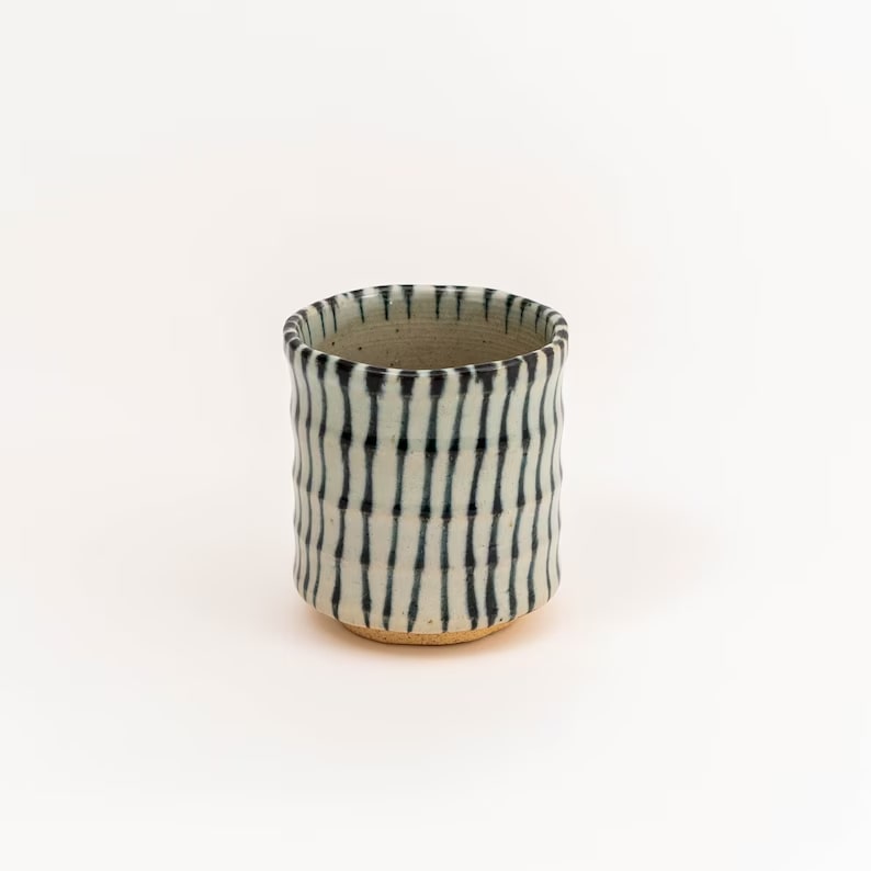 Japanese ceramic tea cup featuring black and blue stripes
