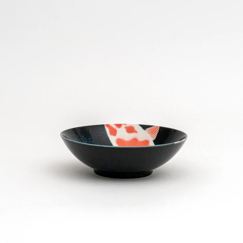 Ceramic dinnerware featuring koi fish patterns in navy blue.