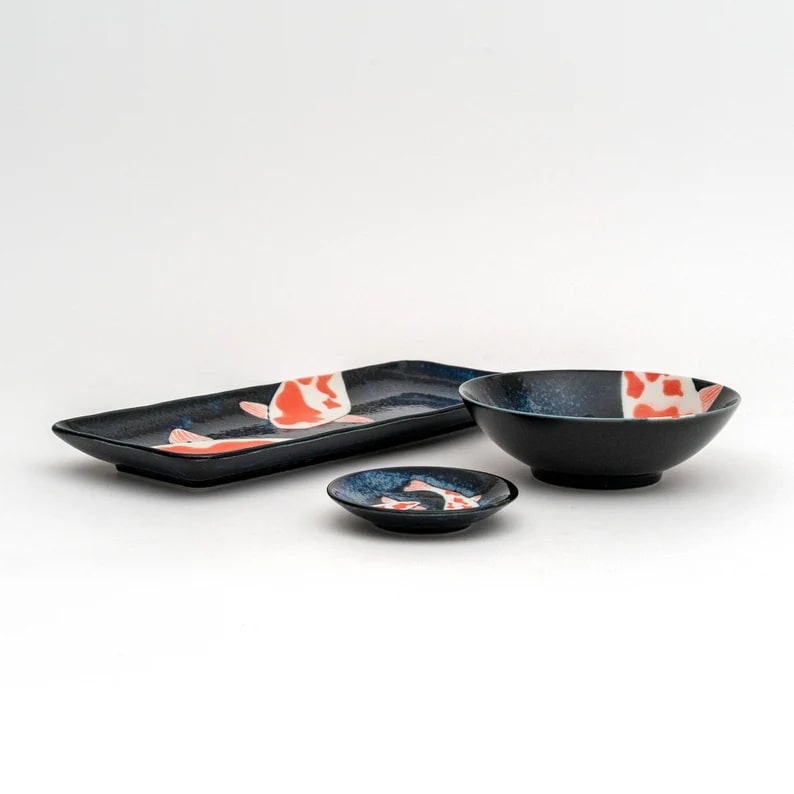 Ceramic dinnerware featuring koi fish patterns in navy blue.