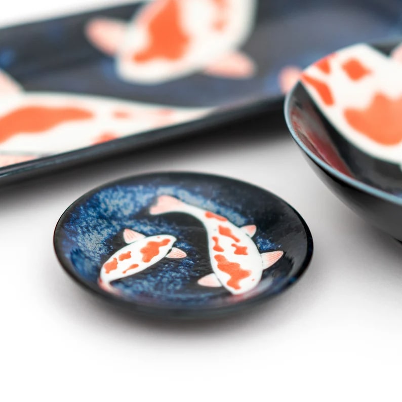 Japanese sushi plates with artistic koi fish motifs.