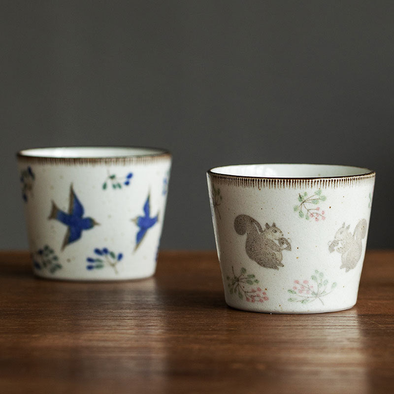 Handcrafted ceramic cup with squirrel motif