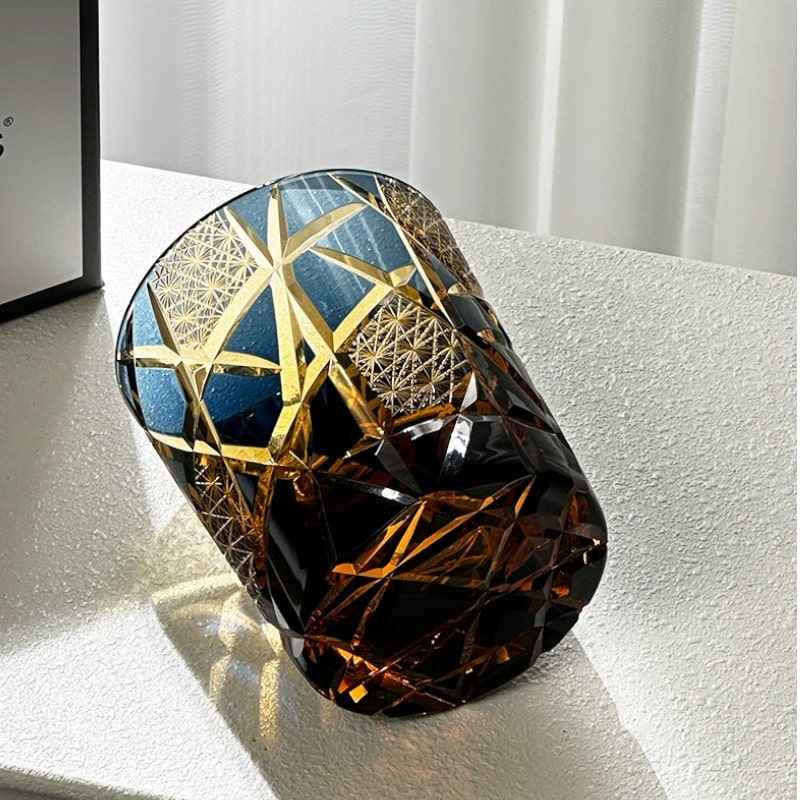 Close-up of handcrafted crystal whiskey glass featuring Twilight of the Gods variant star pattern.