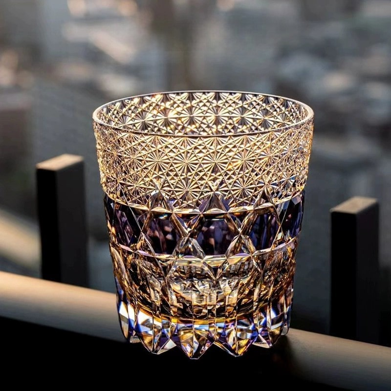 Close-up of handcrafted crystal whiskey glass in purple, showcasing intricate Edo Kiriko carving.