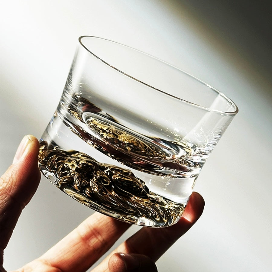 Close-up of handcrafted whiskey glass featuring a sleek design and detailed base.