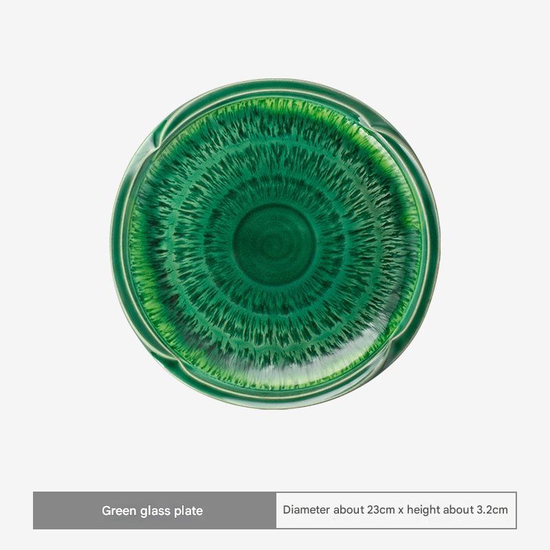 Japanese dessert plate with green glaze on wooden table.