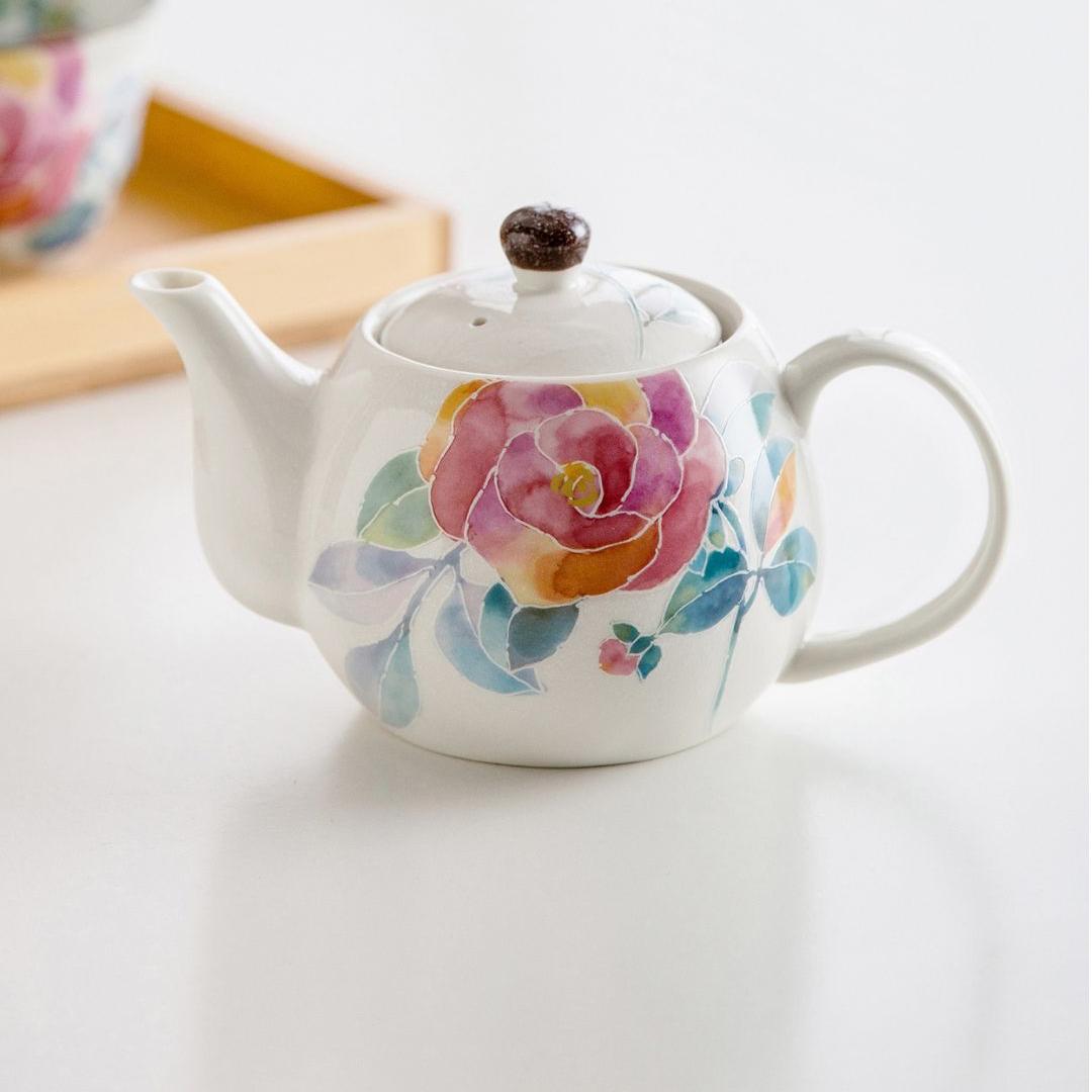 Elegant teapot set displayed on a wooden serving tray