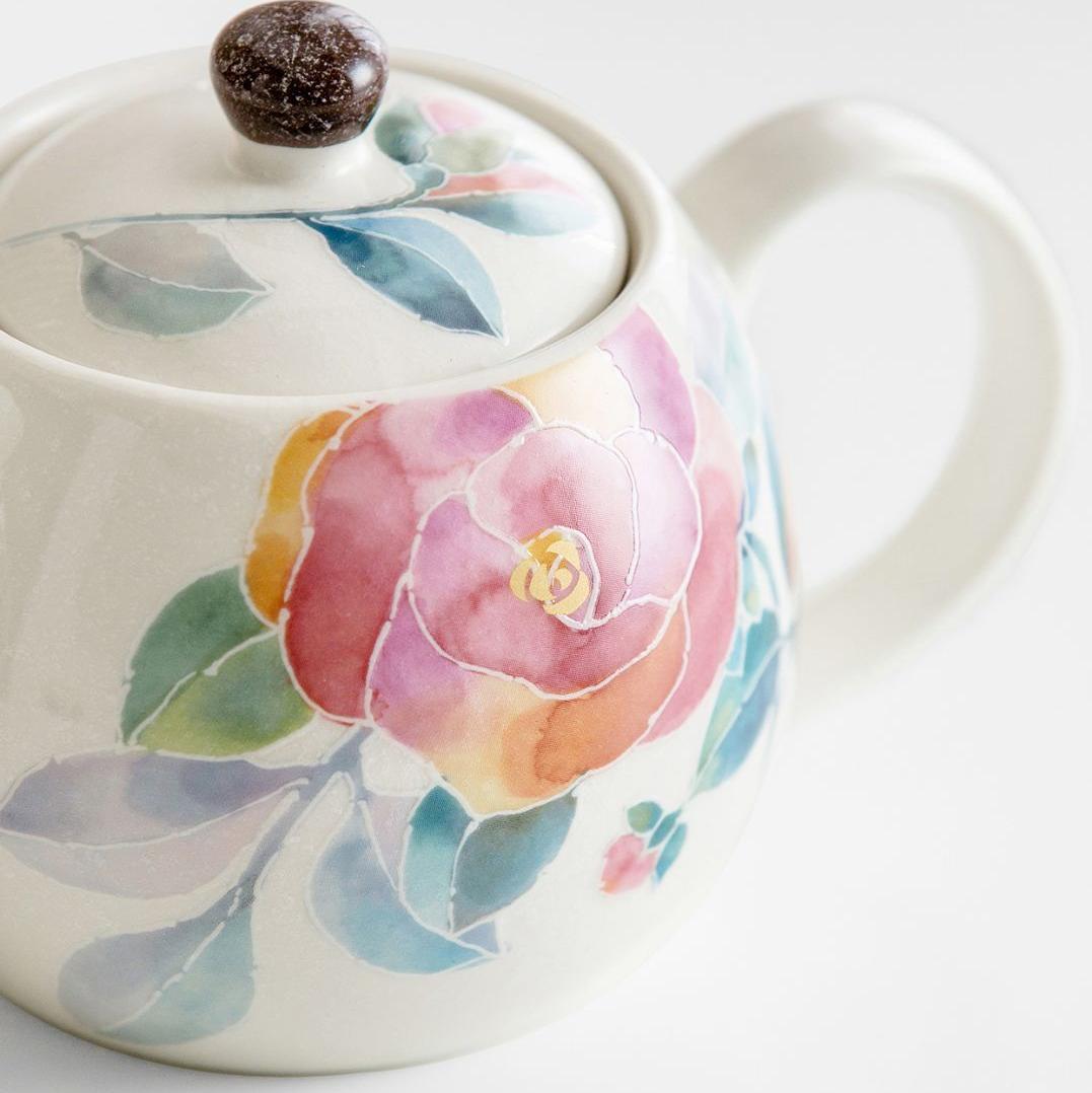 Collection of hand-painted floral teapot sets with cups