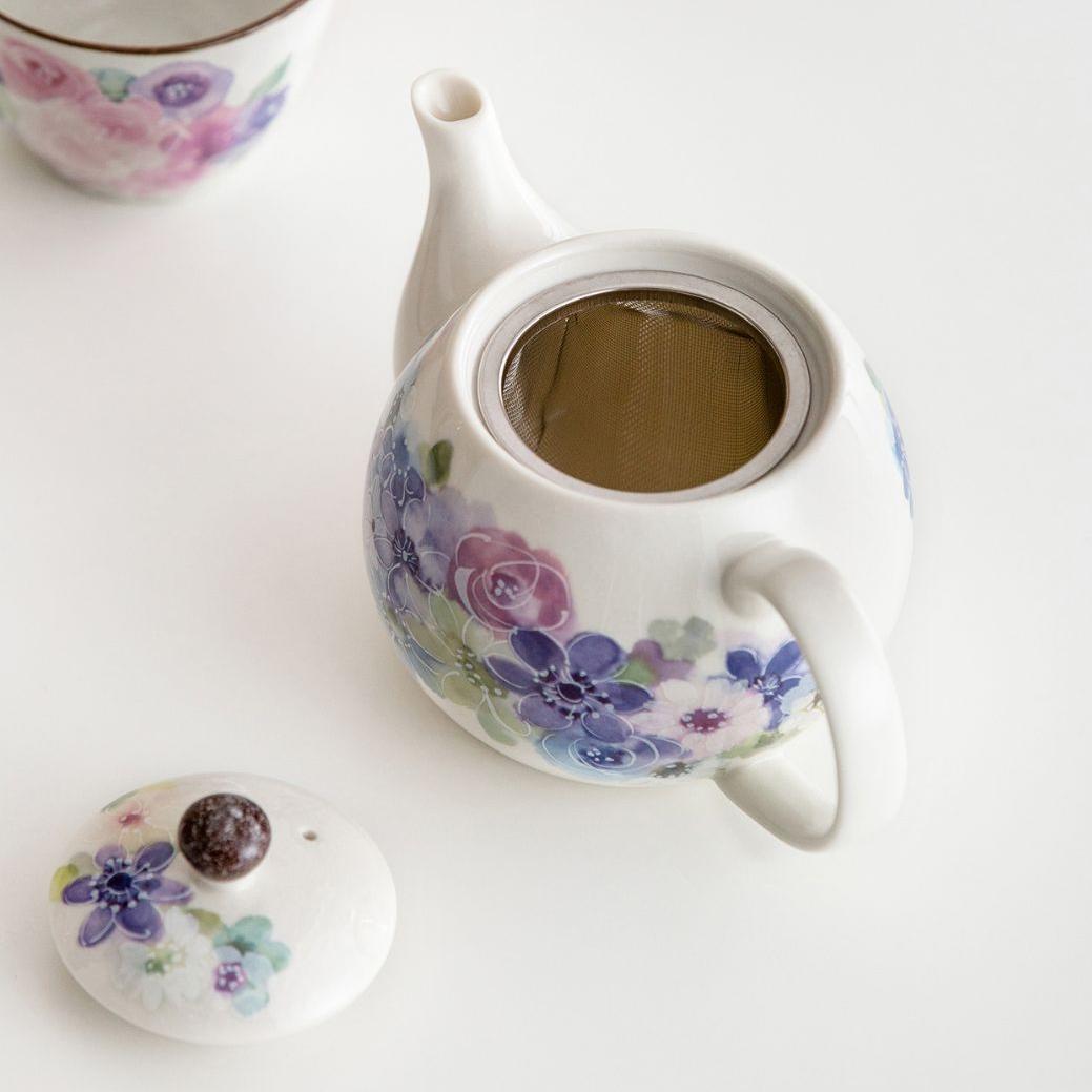 Collection of hand-painted floral teapot sets with cups