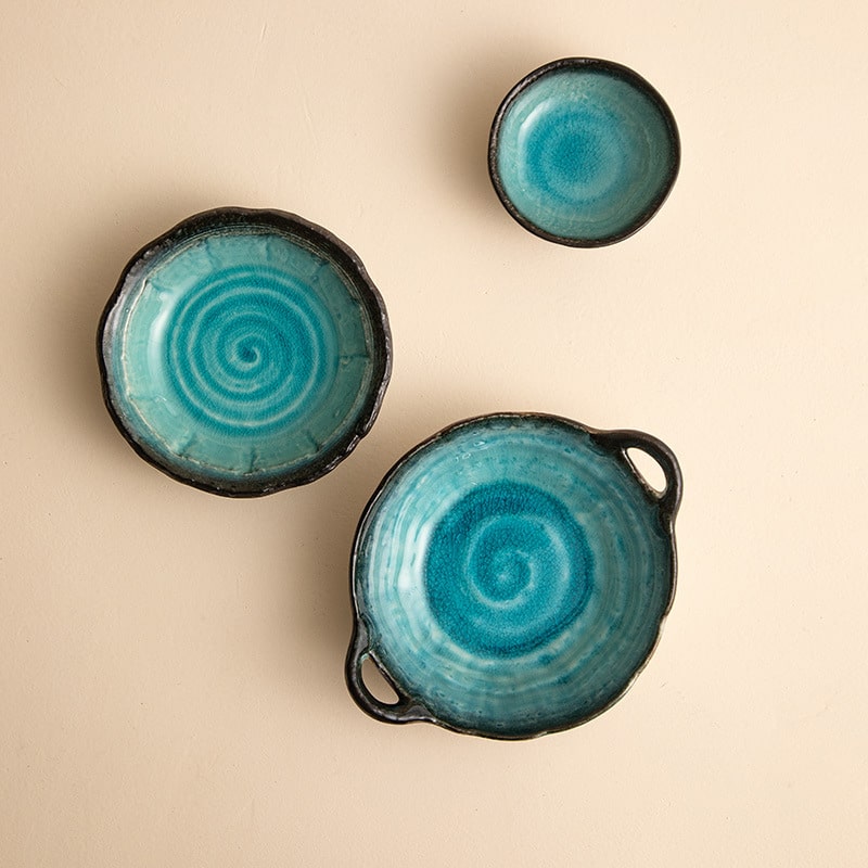 Mino Yaki Turkey Blue ceramic bowls and plates with spiral design.