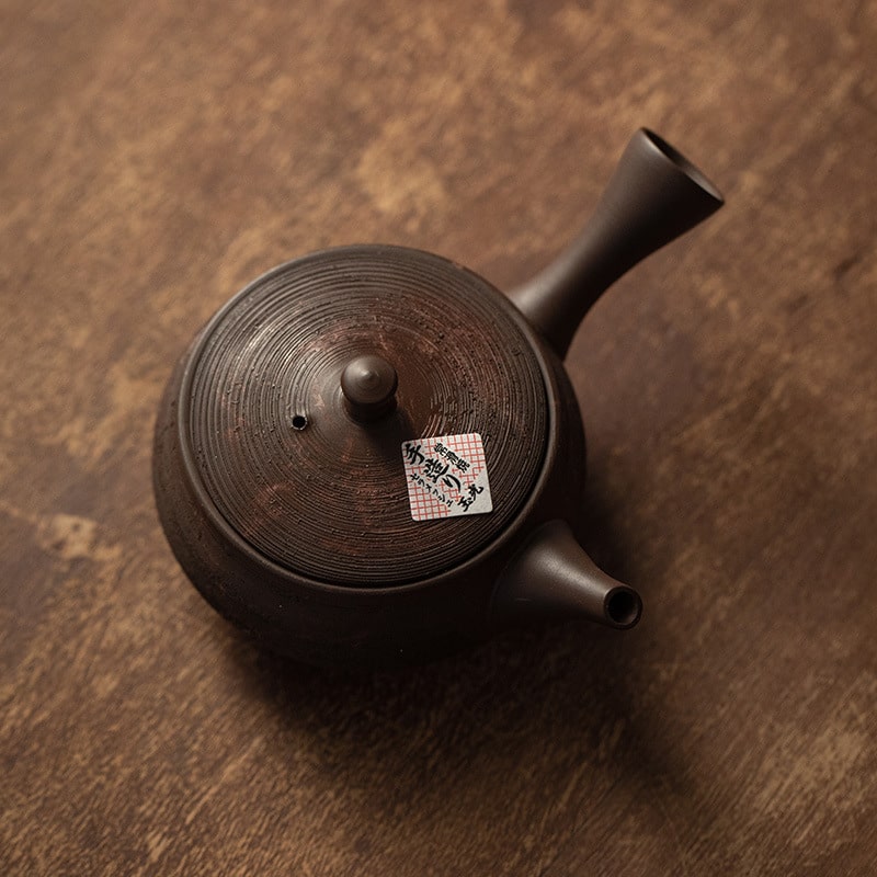 Side view of the Tokoname Yaki handmade jade light teapot with a side handle.