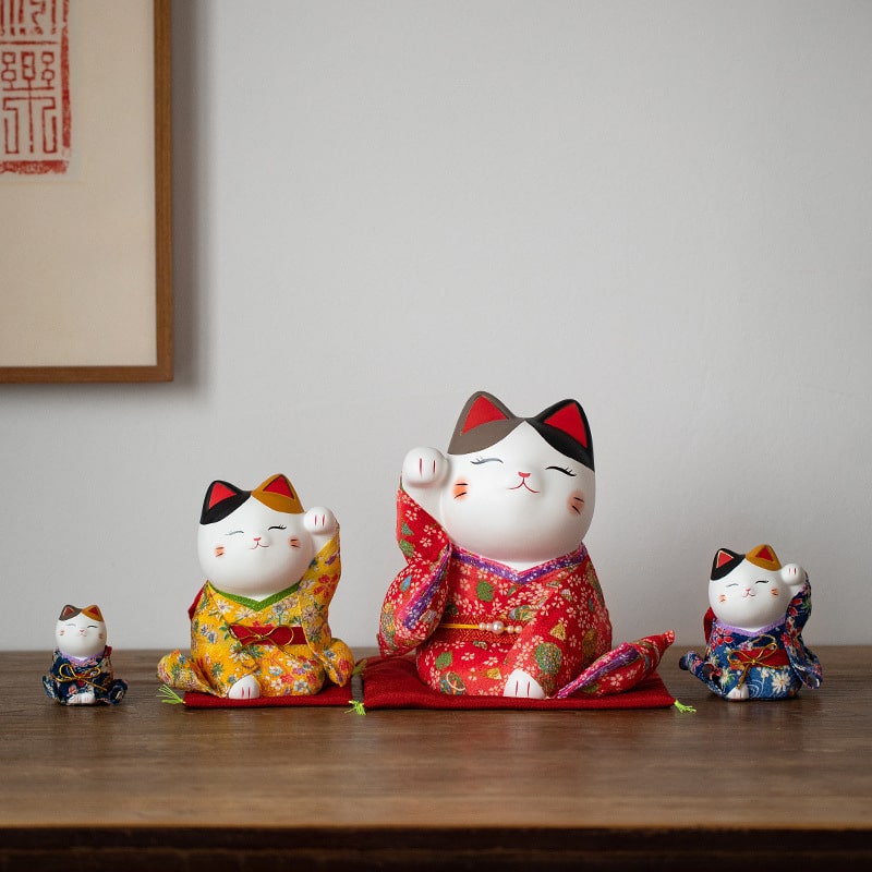 Handcrafted Japanese lucky cat figurine in a red kimono