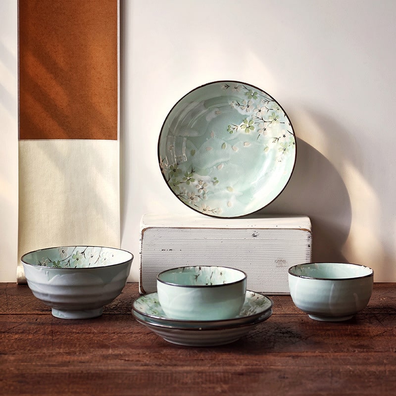 Full tableware set with cherry blossom design ceramic plates.