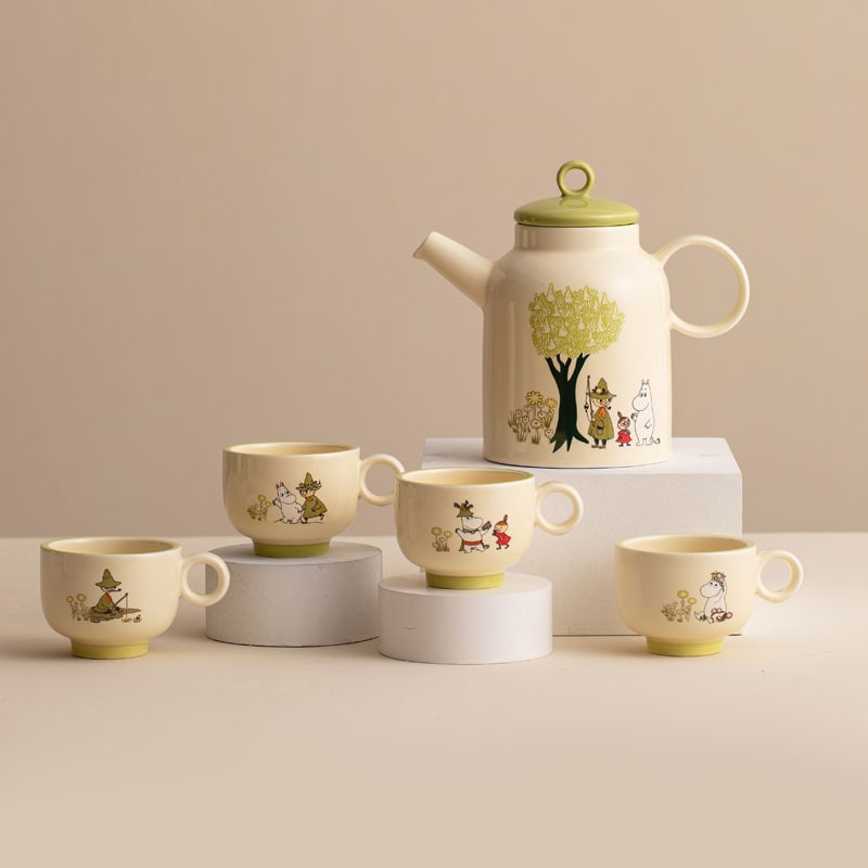 Moomin tea set with green-lidded teapot and matching cups.