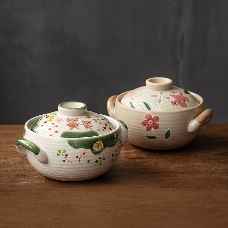 Hand-painted ceramic casserole dishes with floral and whimsical designs