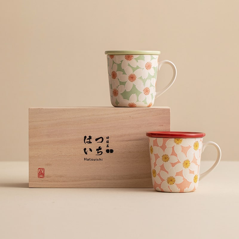 Floral ceramic cups with matching lids and pastel designs