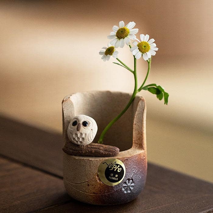 Japanese handmade cat pottery holder with earthy textures.