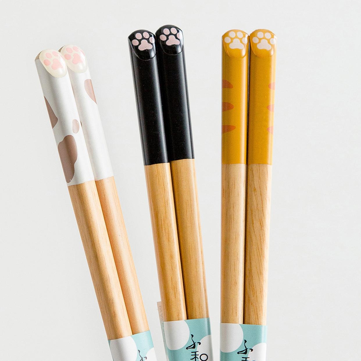 Playful cat-themed chopsticks resting on ceramic holders