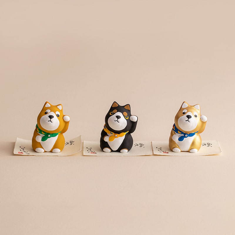 Trio of Japanese Shiba Inu figurines in vibrant colors