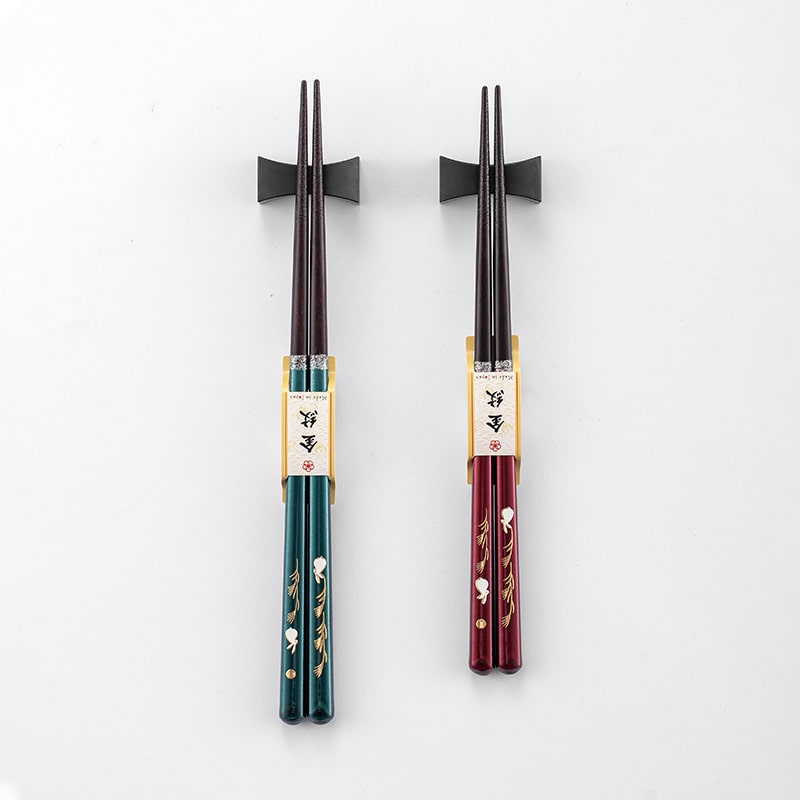 Two pairs of Japanese rabbit-themed solid wood chopsticks on a white background.