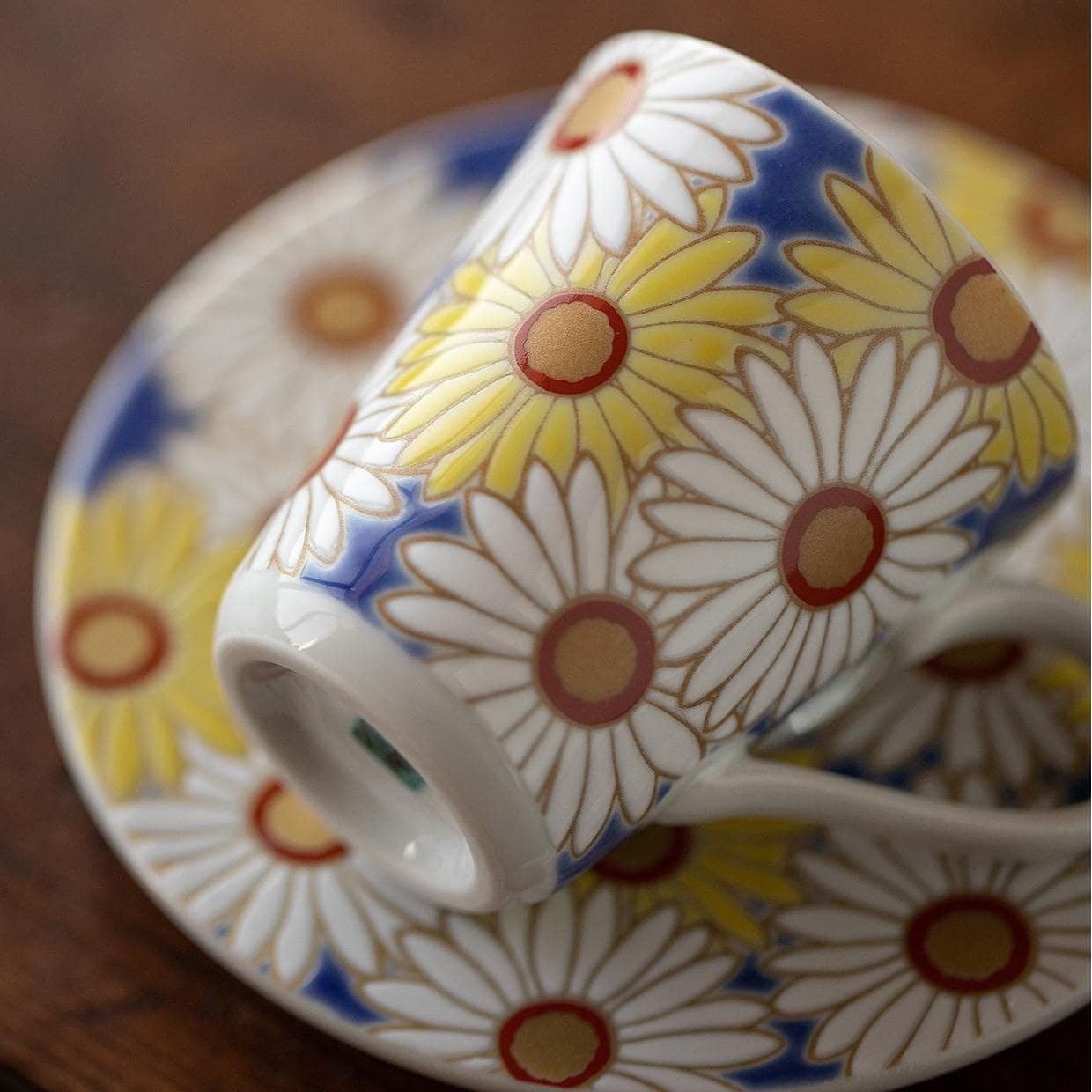 Four espresso cups with distinct vibrant floral designs