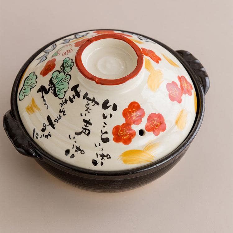 Japanese earthenware cooking pot displayed on a gas stove.