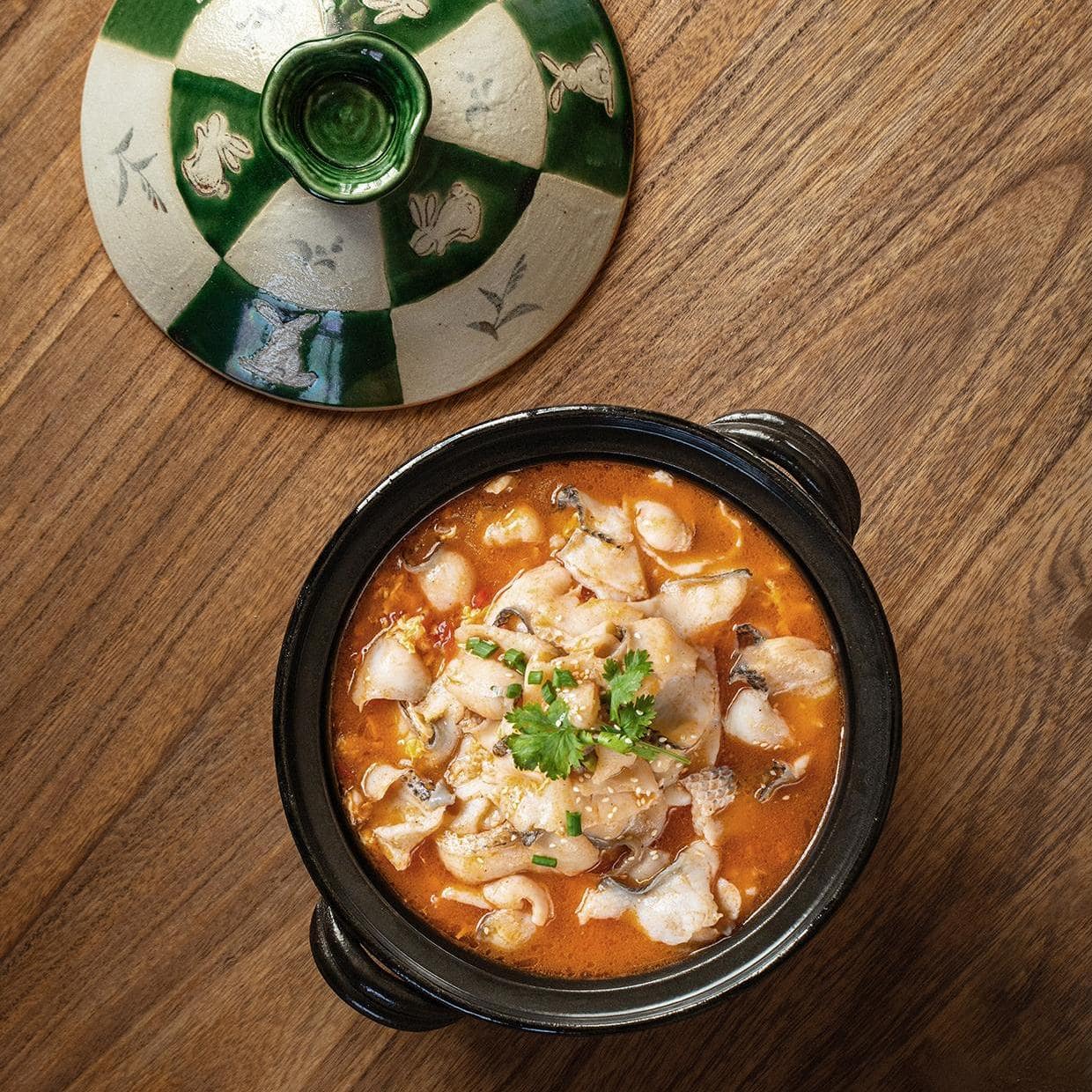 Japanese Oribe clay casserole with soup being served