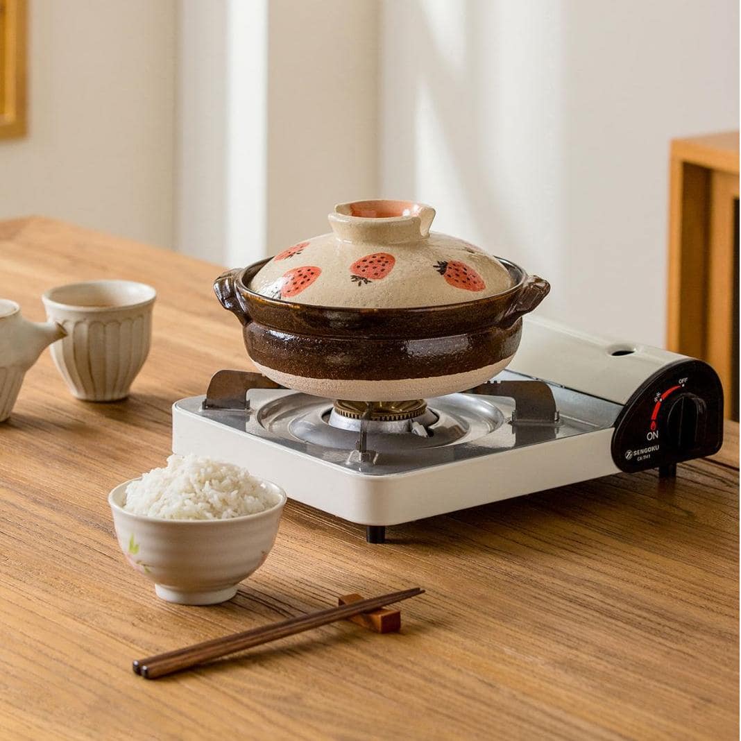 Durable clay pot for cooking and serving hot dishes.