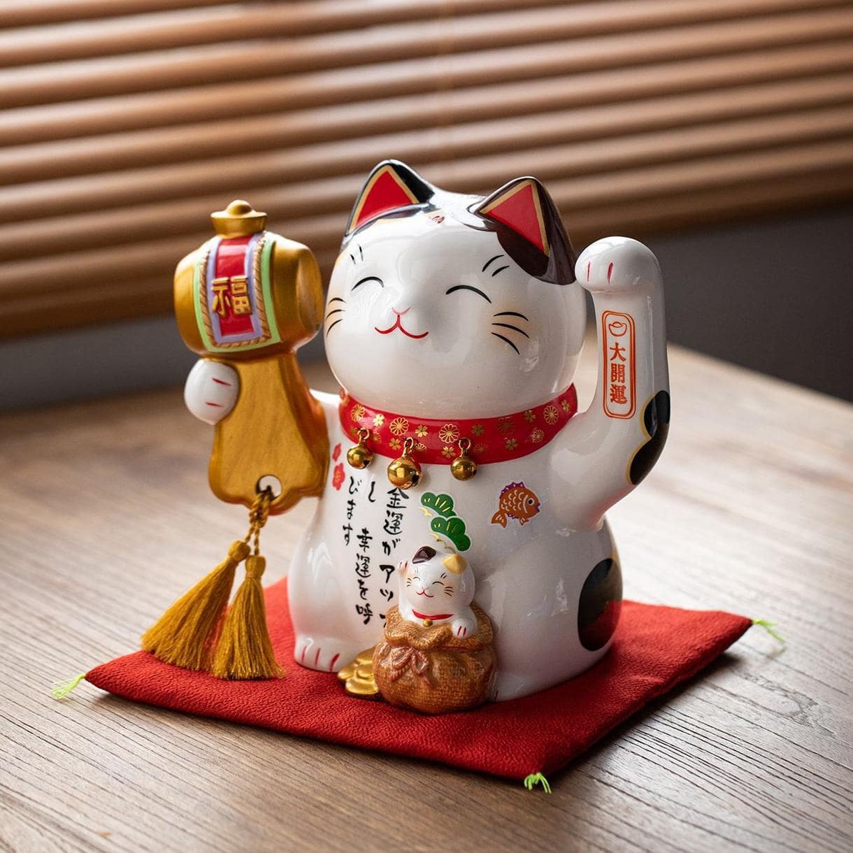 Adorable prosperity cat figurines displayed in a glass cabinet.