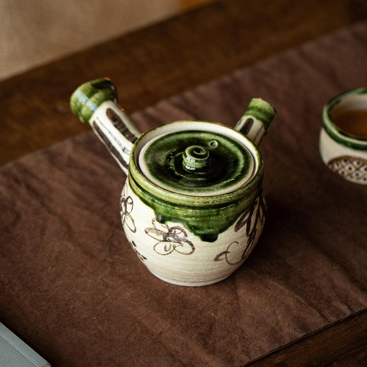 Close-up of anti-scalding handle and built-in mesh filter on Kyusu teapot.